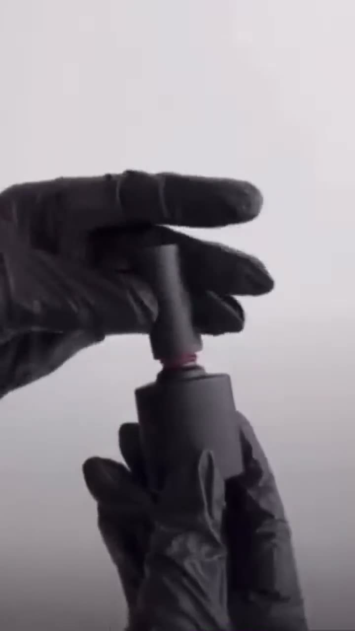 A gloved hand opening a bottle of gel polish at Rullier Beauty & Spa
