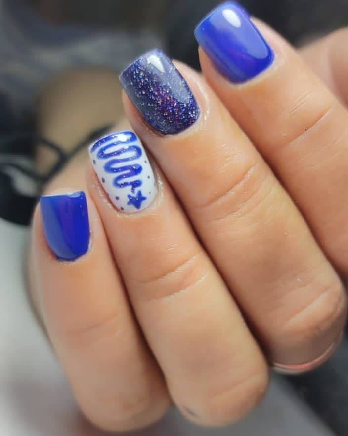 Royal blue nails with a glitter accent finger