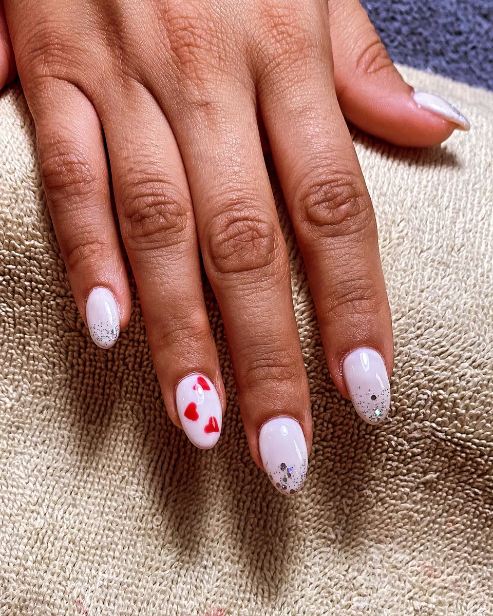 White gel nails with tiny red hearts